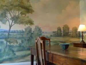Stark dining table and scenic mural wallpaper