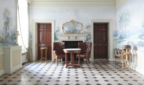 Hedsor House foyer with scenic mural wallpaper and fireplace